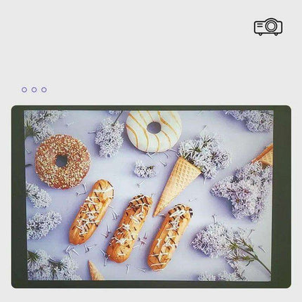 Display screen showing donuts, éclairs, ice cream cones, and lilac flowers.